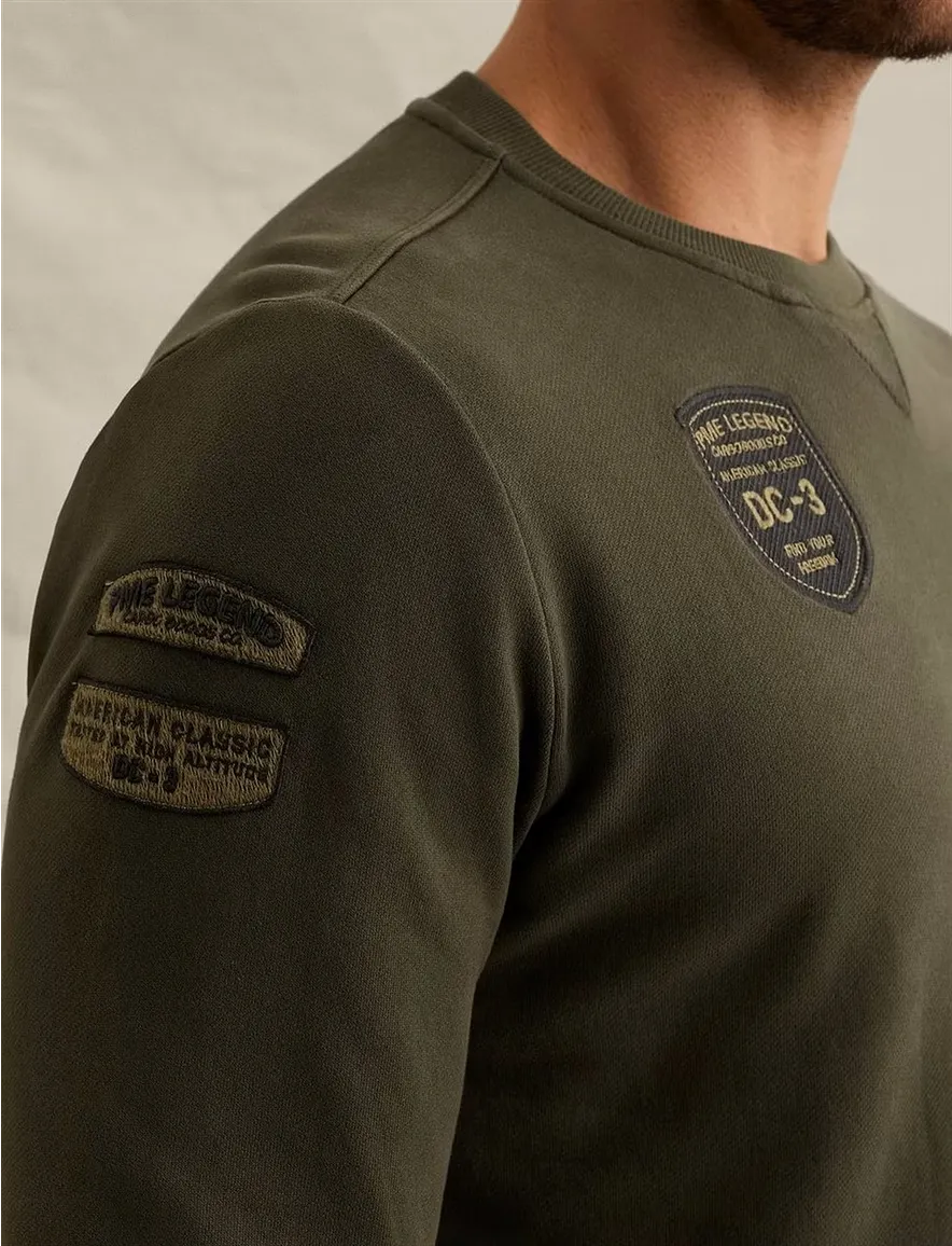 Donkergroene sweater PME Legend embleempjes